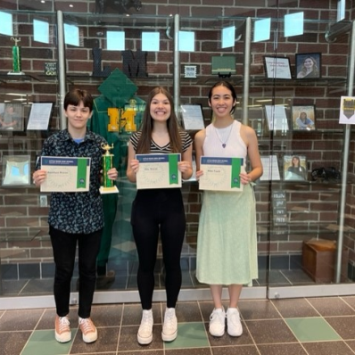 students smiling holding certificate